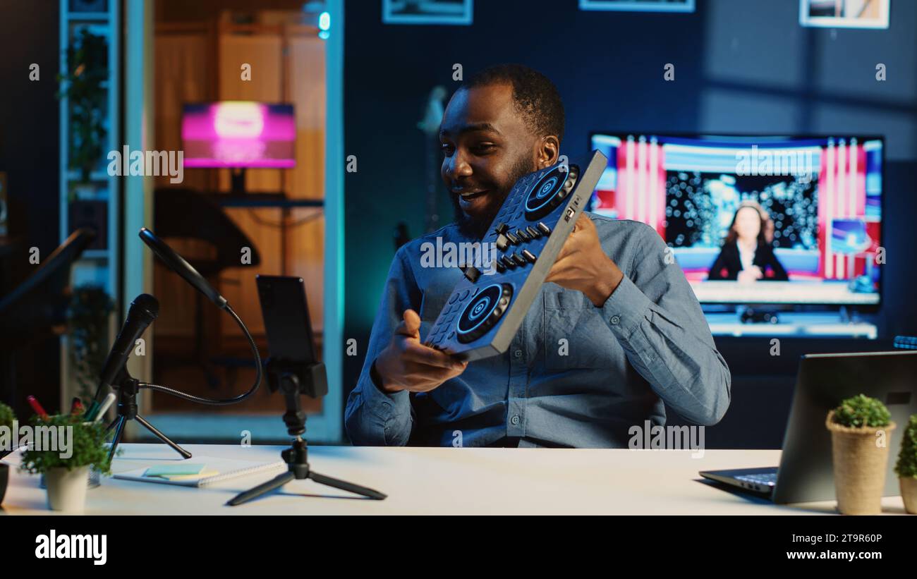 Content creator filming technology review of newly released DJ controller, unboxing it and