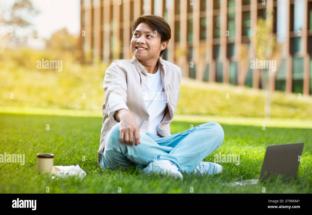 Happy asian guy student chilling at university campus Stock Photo - Alamy
