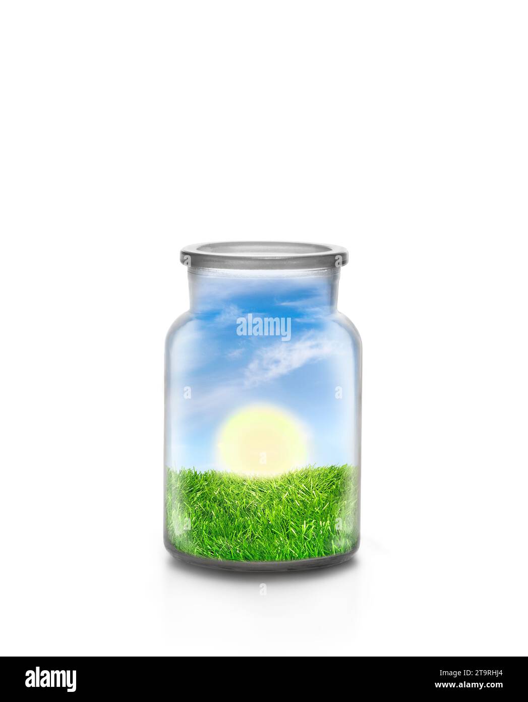 Sunny day over grass landscape inside a chemical bottle against white background. Ecological and sustainable concept. Stock Photo