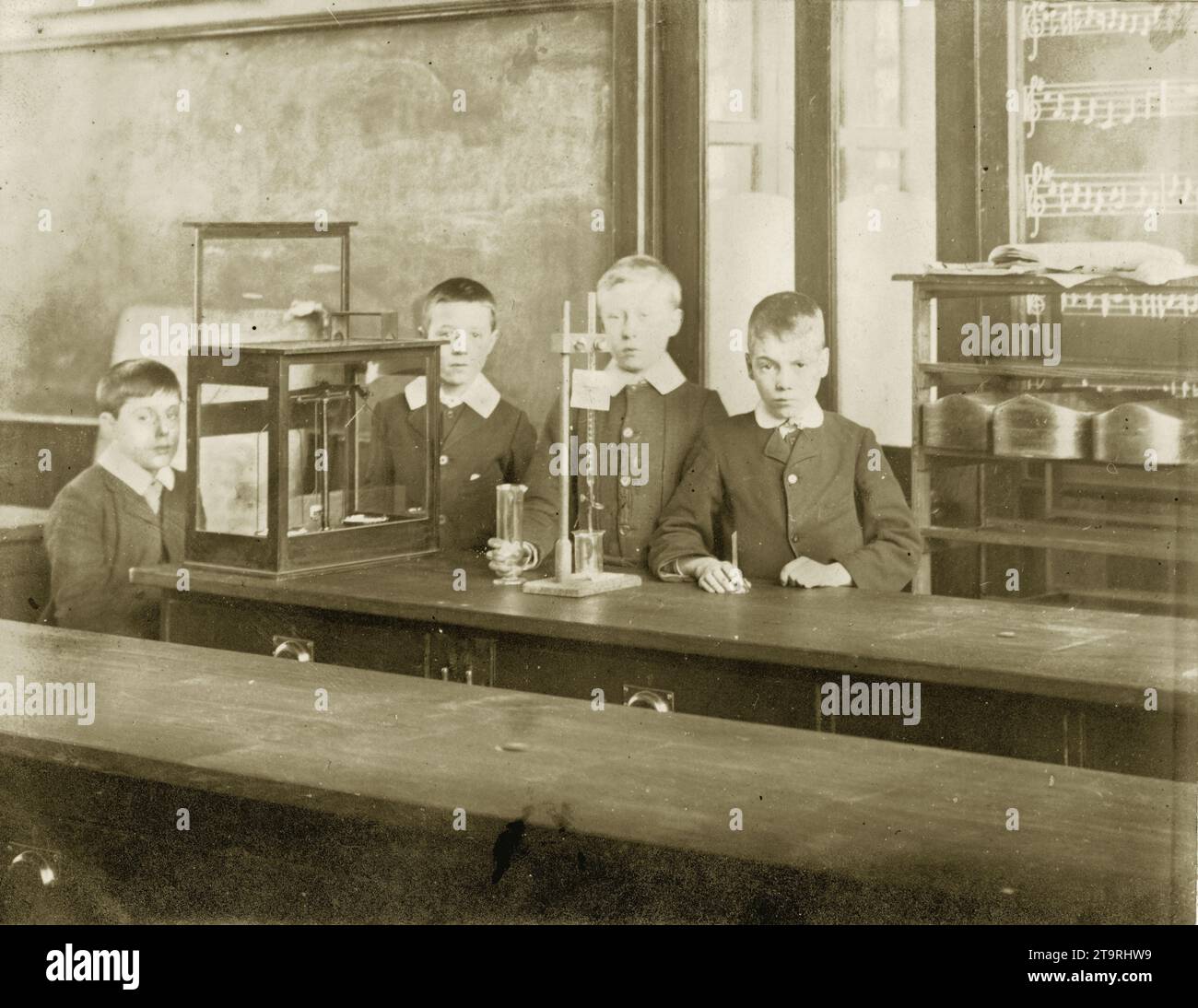Original Edwardian or Victorian postcard of Edwardian or Victorian schoolboys attending science lesson in classroom, with equipment. Circa 1905, U.K. Stock Photo