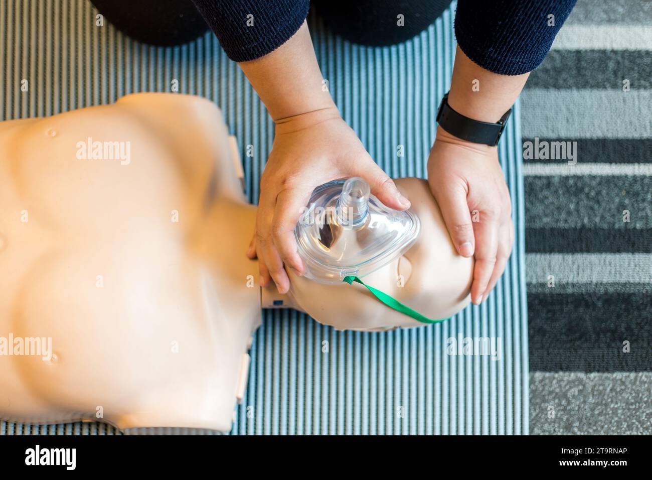 Woman performing CPR training dummy Stock Photo