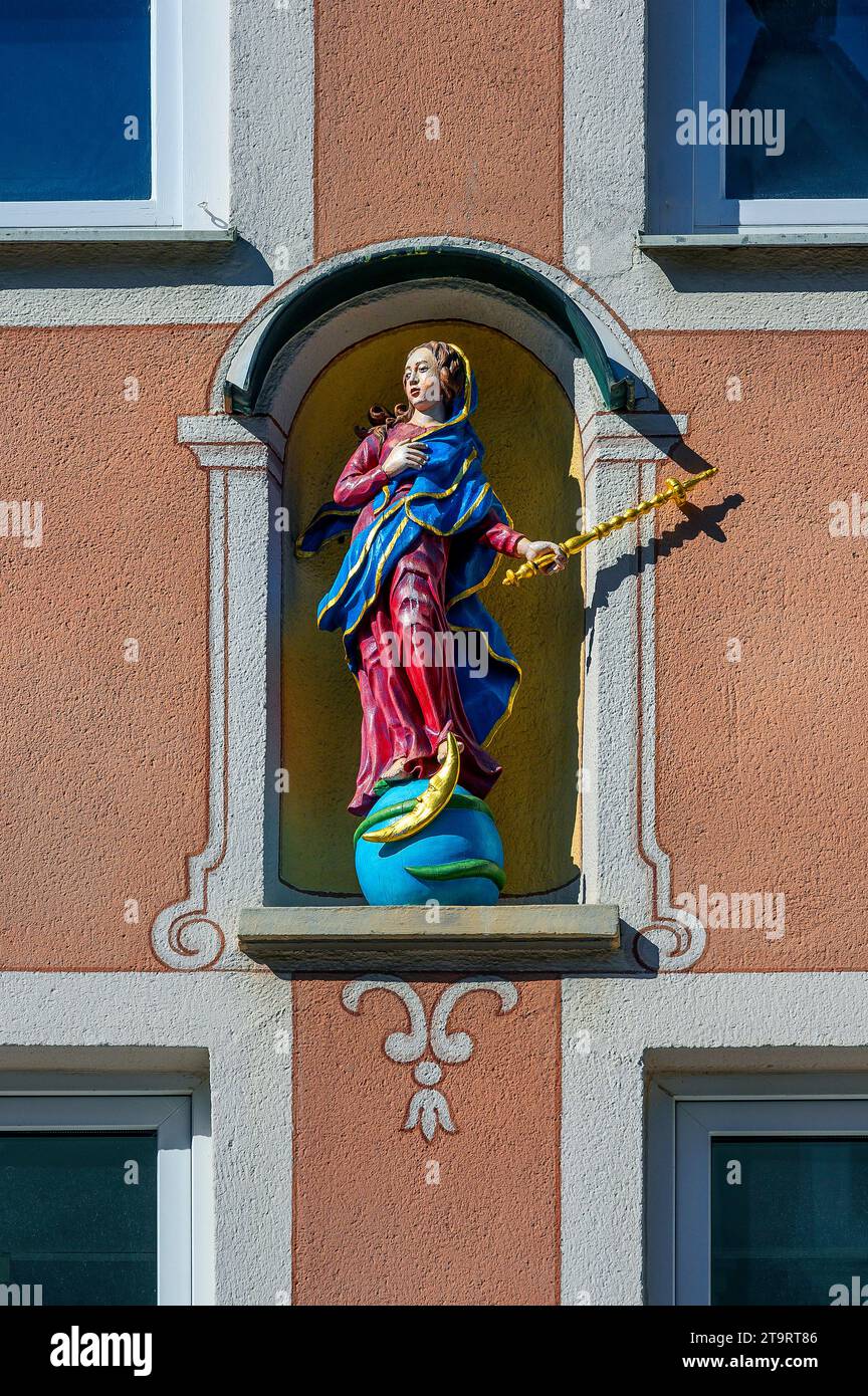 Facade with Madonna figure on globe with moon and snake, Mindelheim, Bavaria, Germany Stock Photo