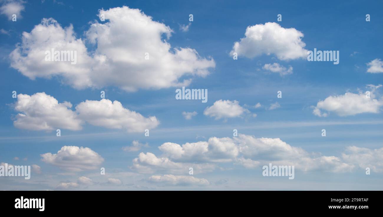 Blue Sky filled with white clouds Stock Photo - Alamy