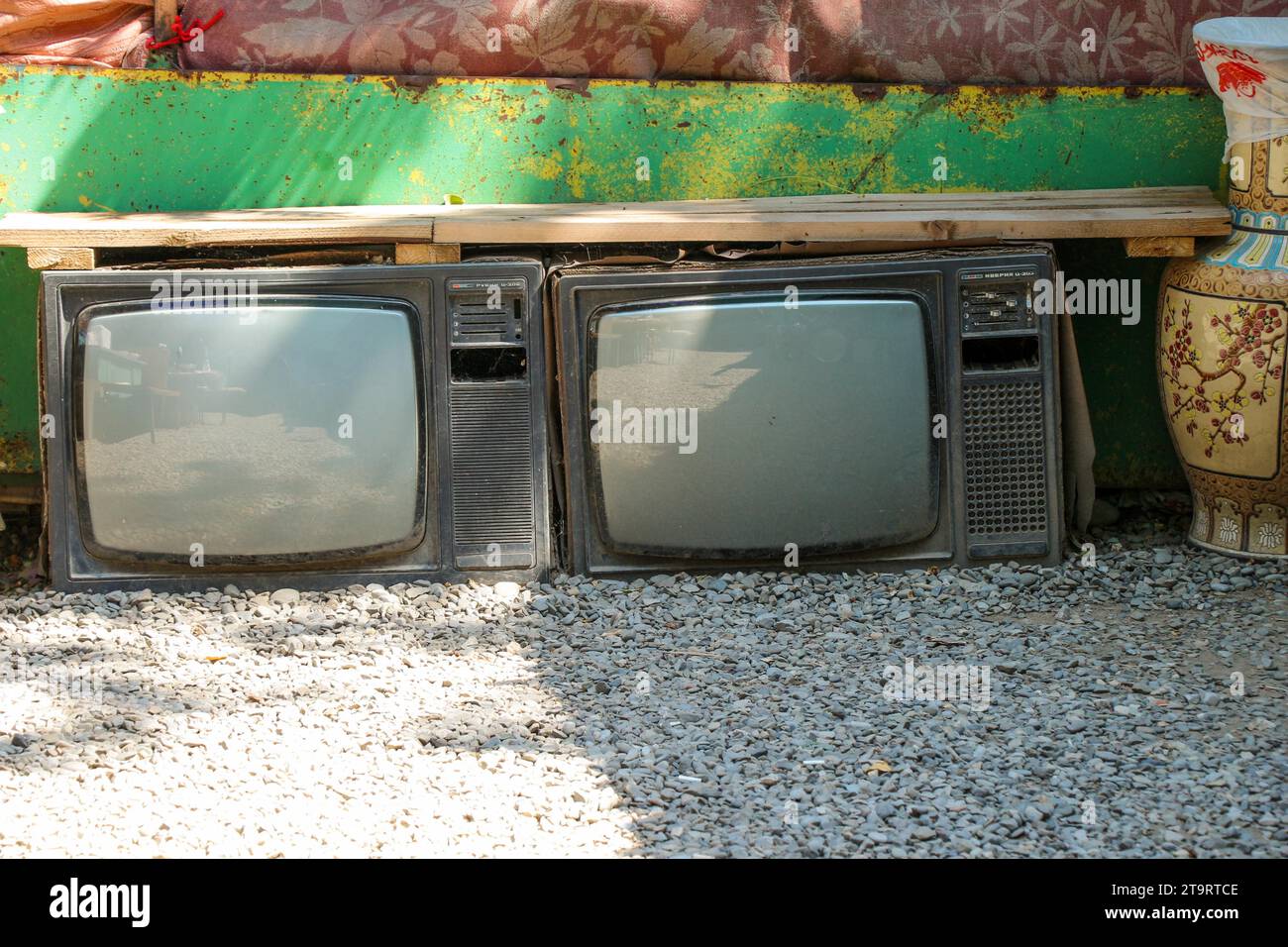 A Broken Television Abandoned on the ground outside in the street Stock Photo