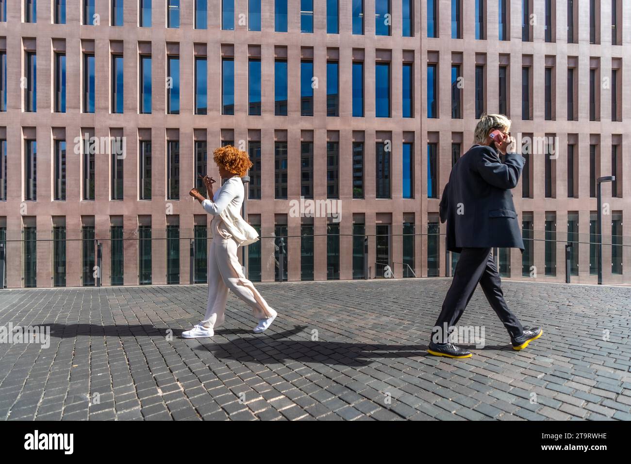 Side view of two business people walking commuting to the office Stock ...