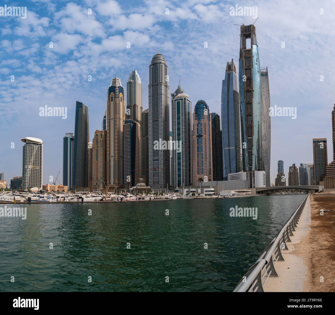 The skyscrapers of Dubai Marina, United Arab Emirates, seen from the sidewalk towards the sea. Stock Photo