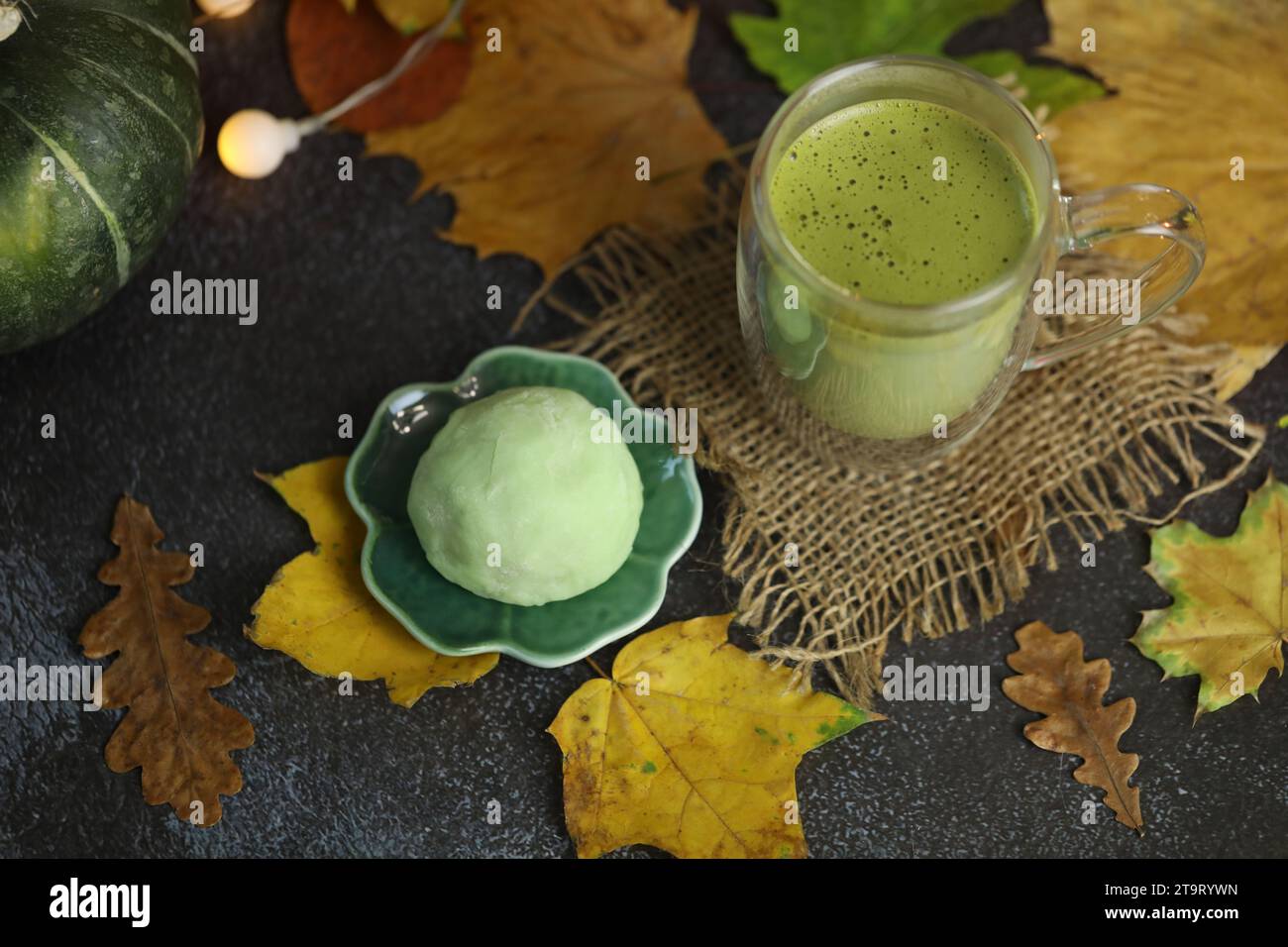 Colorful japanese sweets daifuku or mochi sliced. Sweets close up on the plate with cup of matcha tea Stock Photo