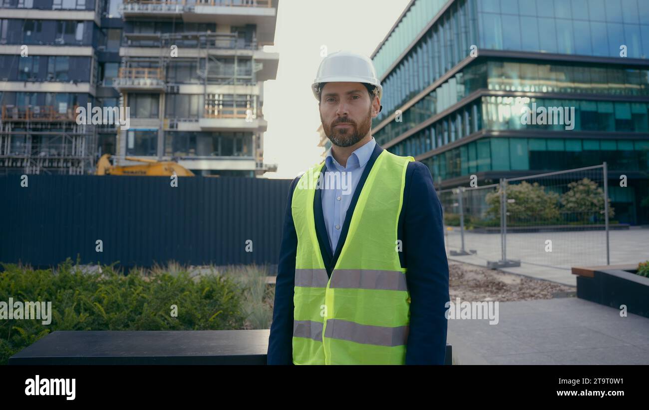 Serious architect build inspector property developer city urban building construction industry Caucasian middle-aged man worker in hardhat male Stock Photo