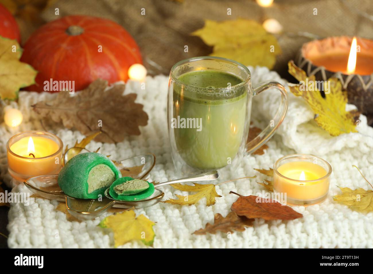 Colorful japanese sweets daifuku or mochi sliced. Sweets close up on the plate with cup of matcha tea Stock Photo