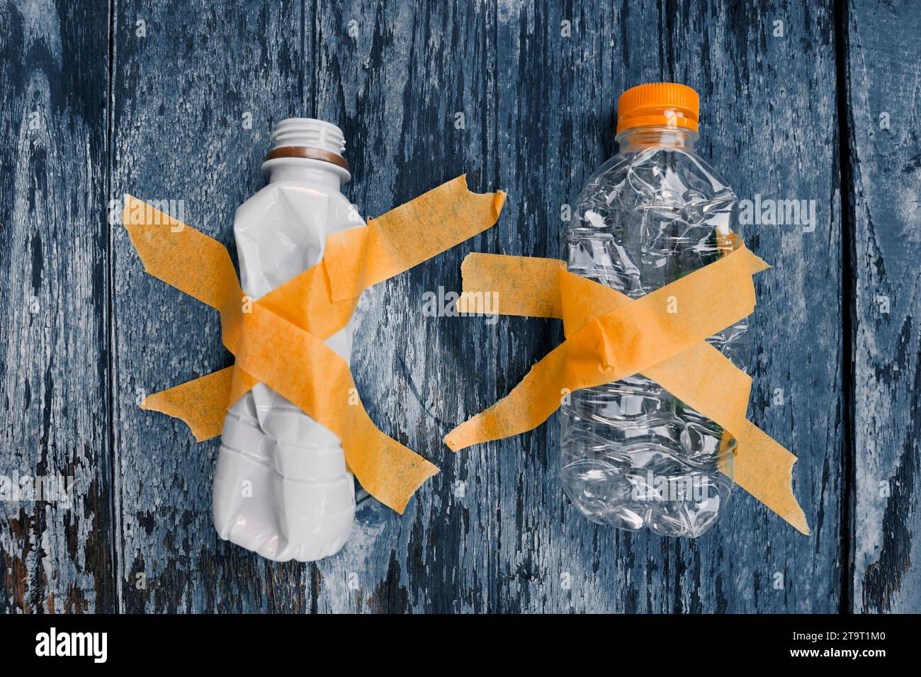 Collecting different types of plastic bottles on wood tables for recycling. zero-waste, garbage and pollution, global warming, and climate change. Stock Photo