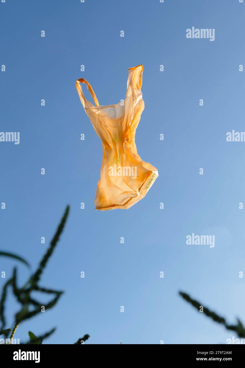 Used plastic bags floating in the air and sky, garbage and pollution, global warming and climate change. Stock Photo