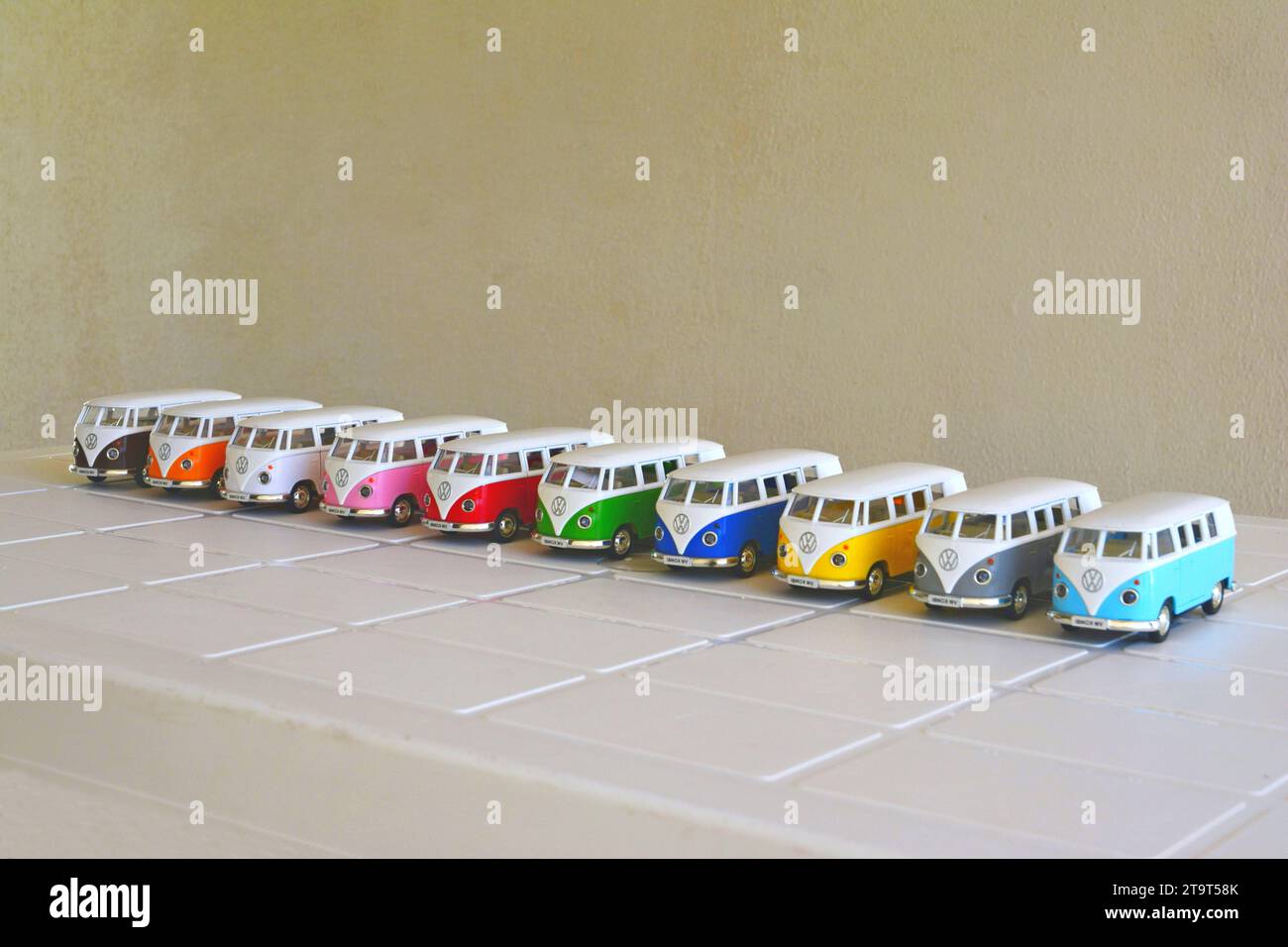Van. Diecast, Iron miniature of vans of various colors, Brazil, South America, side view, selective focus on white table on white background, lined u Stock Photo