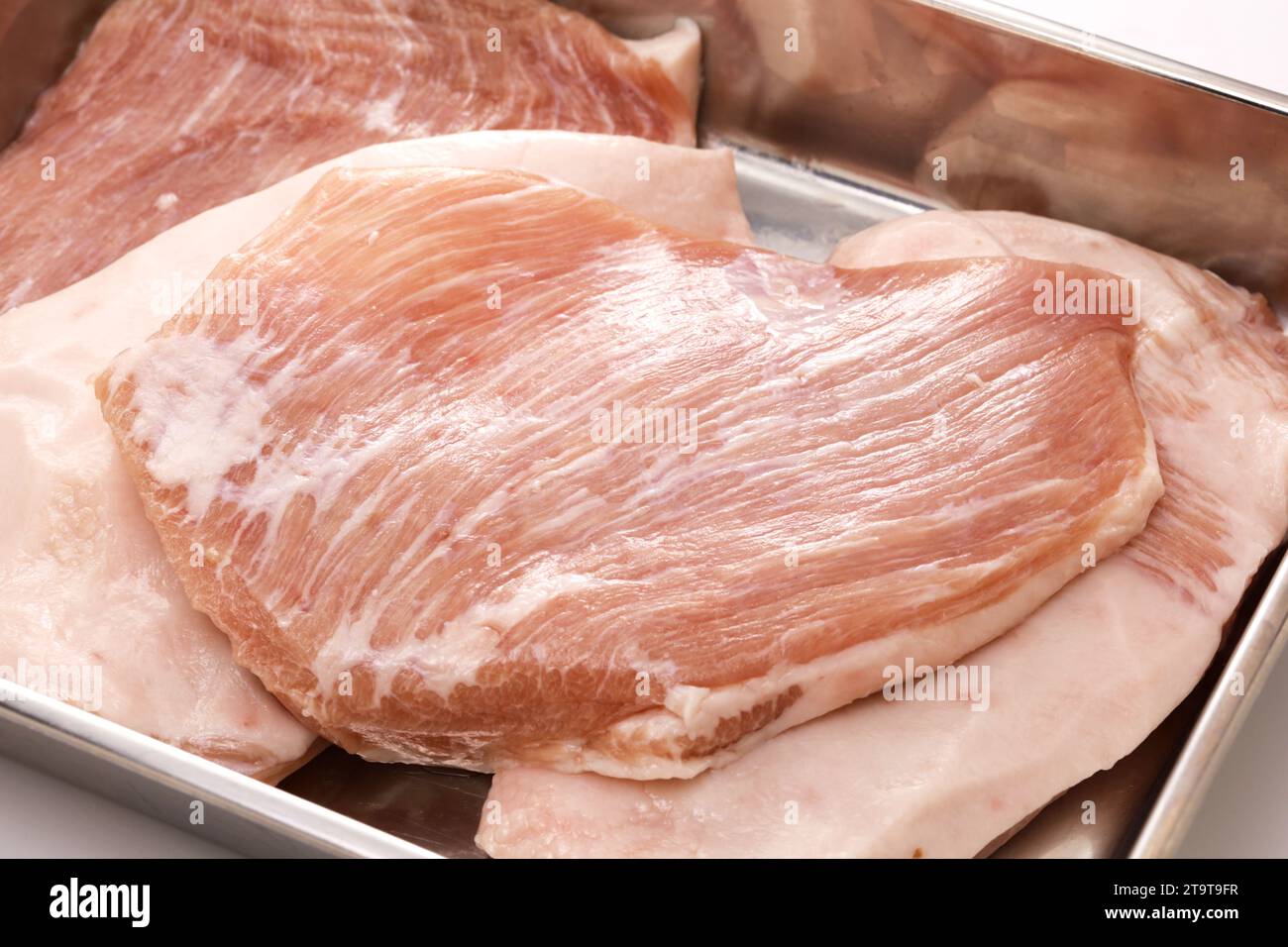 pork jowl meat in a butcher tray Stock Photo