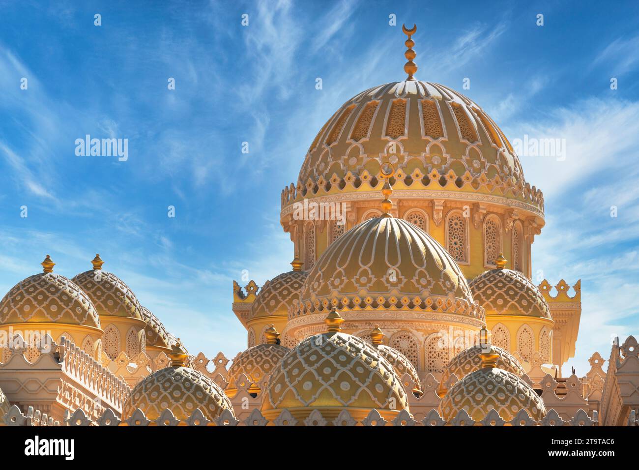 Domes of Al Mina Mosque in Hurghada, Egypt, shining on the background if deep blue sky Stock Photo