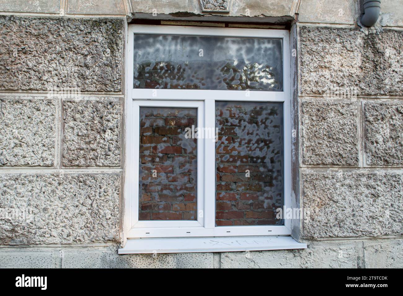 Newly installed window with a brick wall behind it Stock Photo
