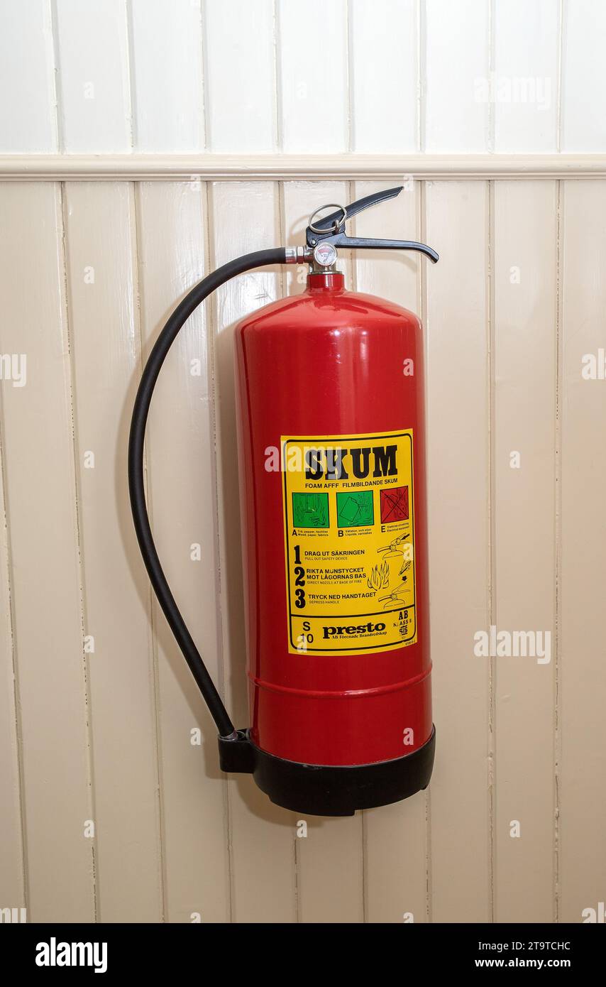 Fire extinguisher in the stairwell in an apartment building Stock Photo