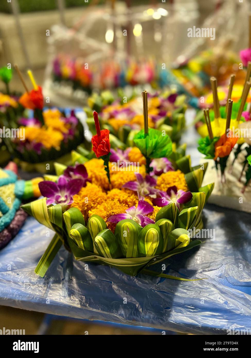 Bangkok, Thailand. 27th Nov, 2023. Krathongs lie on a stall. The small rafts are made of banana trees or expanded polystyrene and are decorated with flowers, incense sticks and candles. Thailand always celebrates the Loi Krathong festival of lights on the day of the full moon in the twelfth month of the traditional calendar. The small rafts are lowered into the water in rivers or lakes to pay homage to the Hindu water goddess Mae Phra Khongkha. Credit: Carola Frentzen/dpa/Alamy Live News Stock Photo
