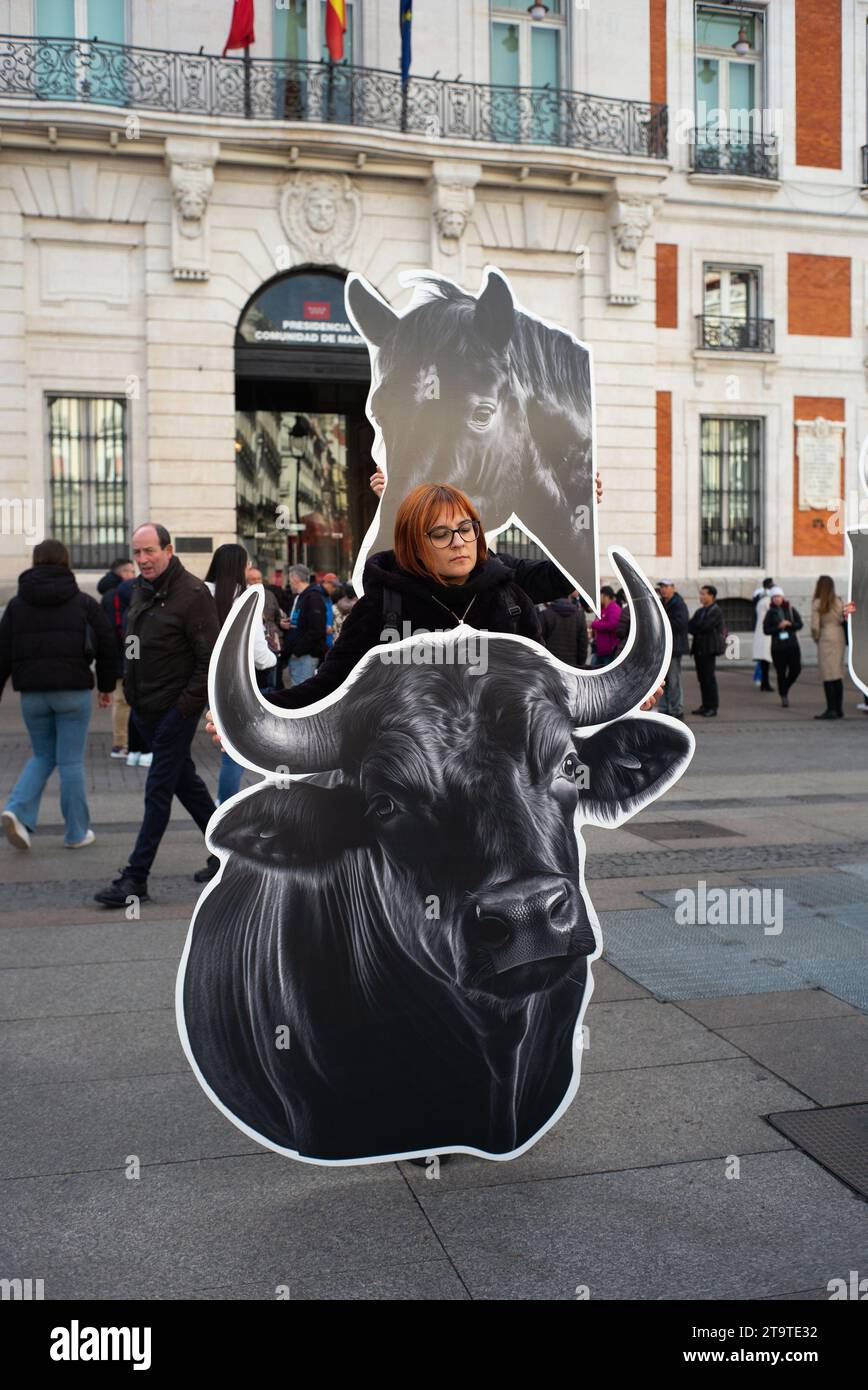 Madrid, Spain. 27th Nov, 2023. Several people show flags and banners with images of bulls, during a demonstration against bullfighting, at the Puerta del Sol, on 27 November, 2023 in Madrid, Spain. (Photo by Oscar Gonzalez/Sipa USA) (Photo by Oscar Gonzalez/Sipa USA) Credit: Sipa USA/Alamy Live News Stock Photo