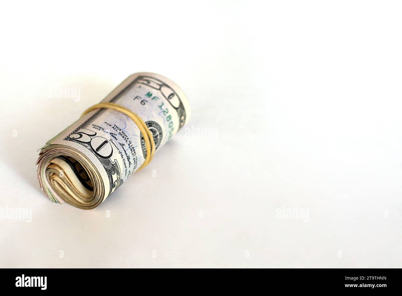 A roll of money on a white background Stock Photo