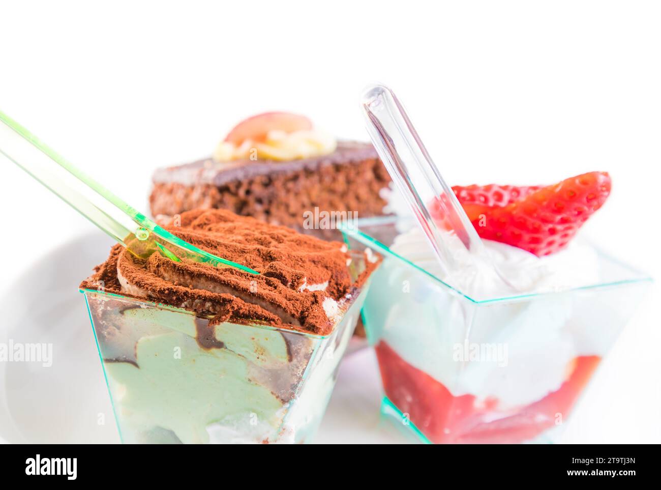 Delicious slice of chocolate cake named tiramisu near little cakes Stock Photo