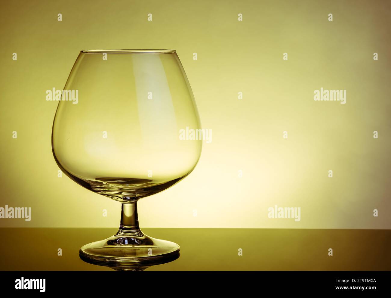 empty snifter of brandy in elegant typical cognac glass on table on