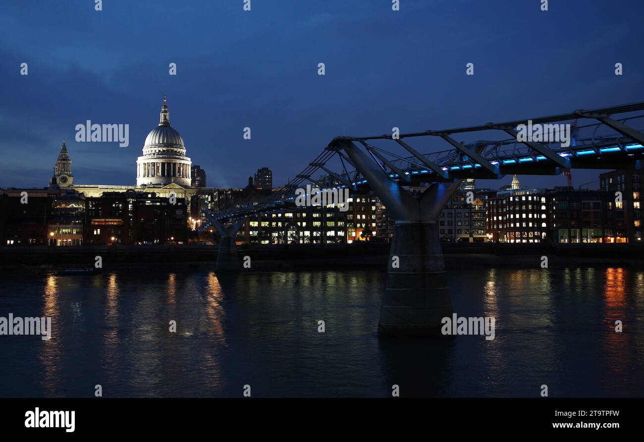 A night panorama stock image of the London Millennium Footbridge and the illuminated St Paul's Cathedral dome Stock Photo