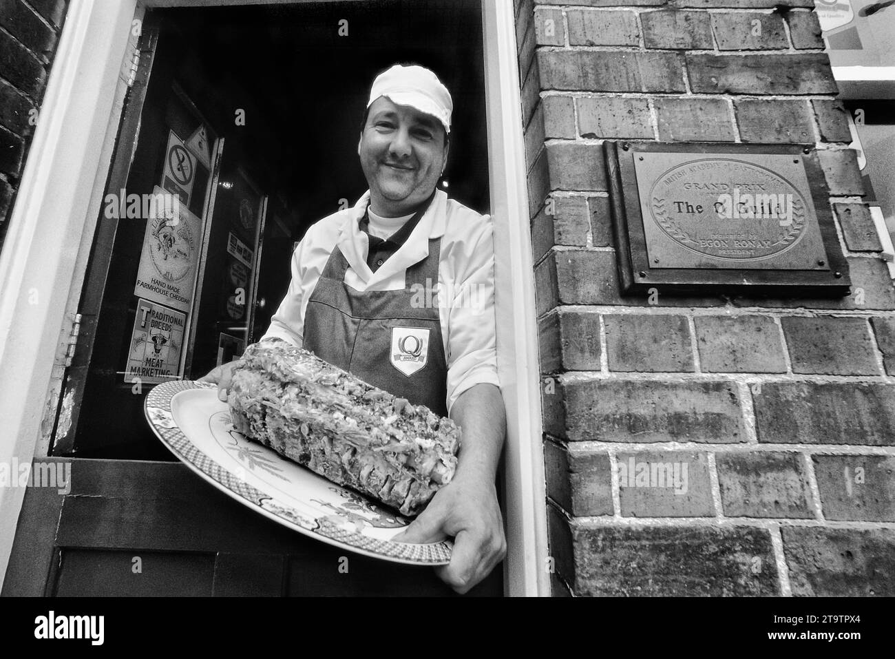 Independent Lincolnshire butcher holding a plate of stuffed Chine. Mareham-le-Fen. England. UK Stock Photo