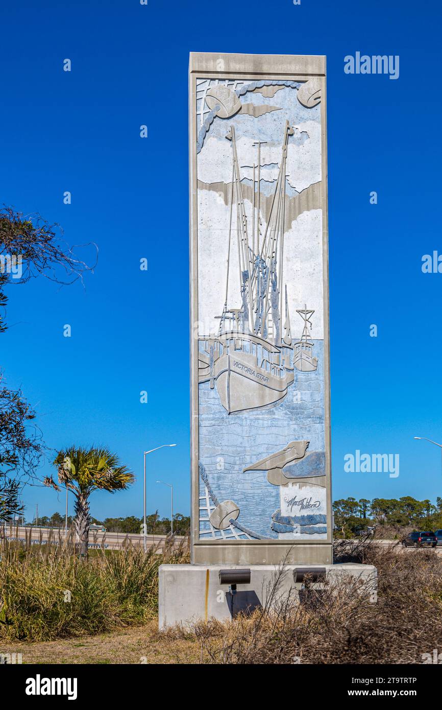 A bas-relief sign showing shrimp boats, created by Mississippi artist Marty Wilson, welcomes tourists to Bay Saint Louis, Mississippi Stock Photo