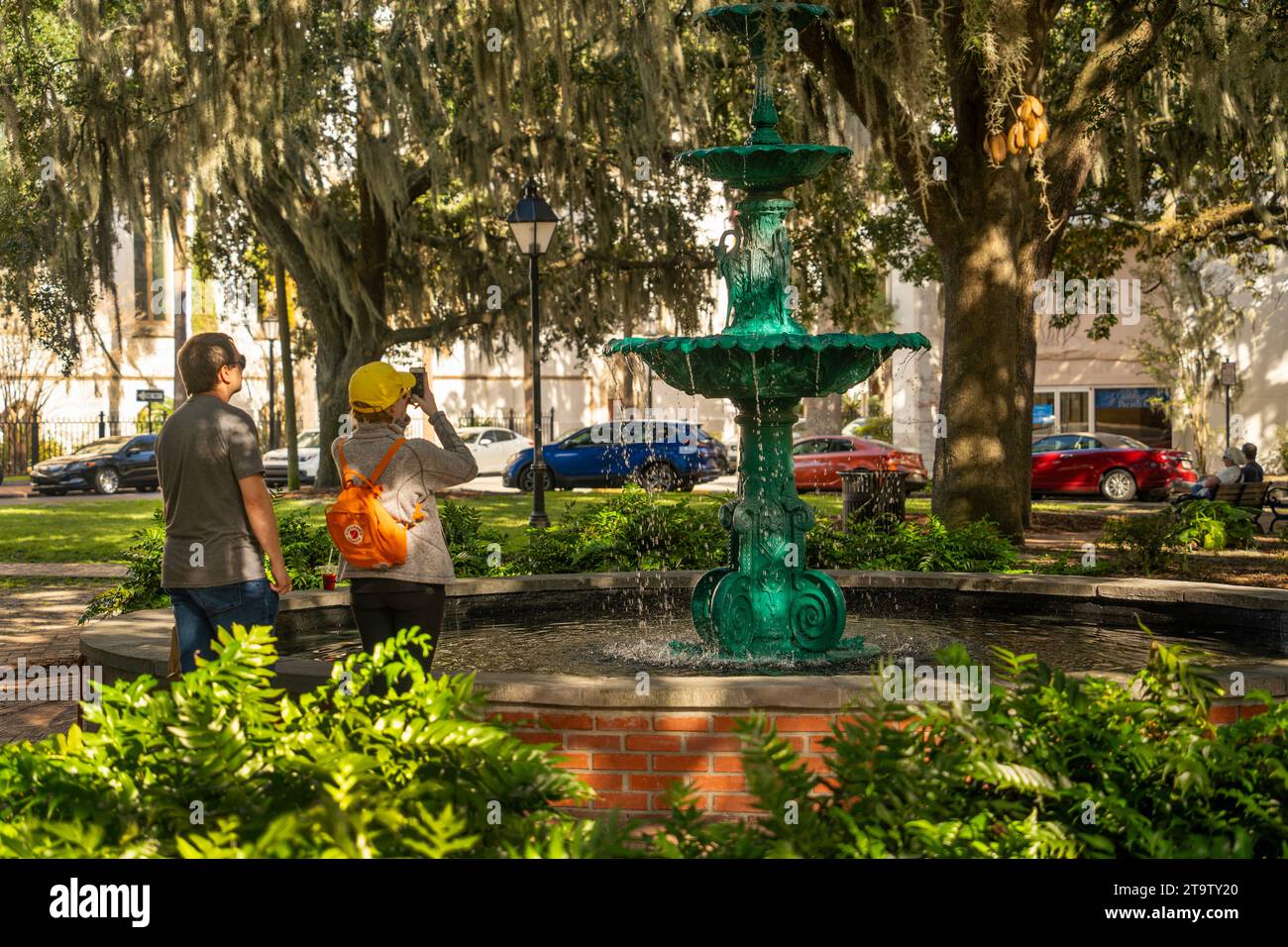 tourists taking photos of a fountain in Lafayette Square Savannah Georgia Stock Photo