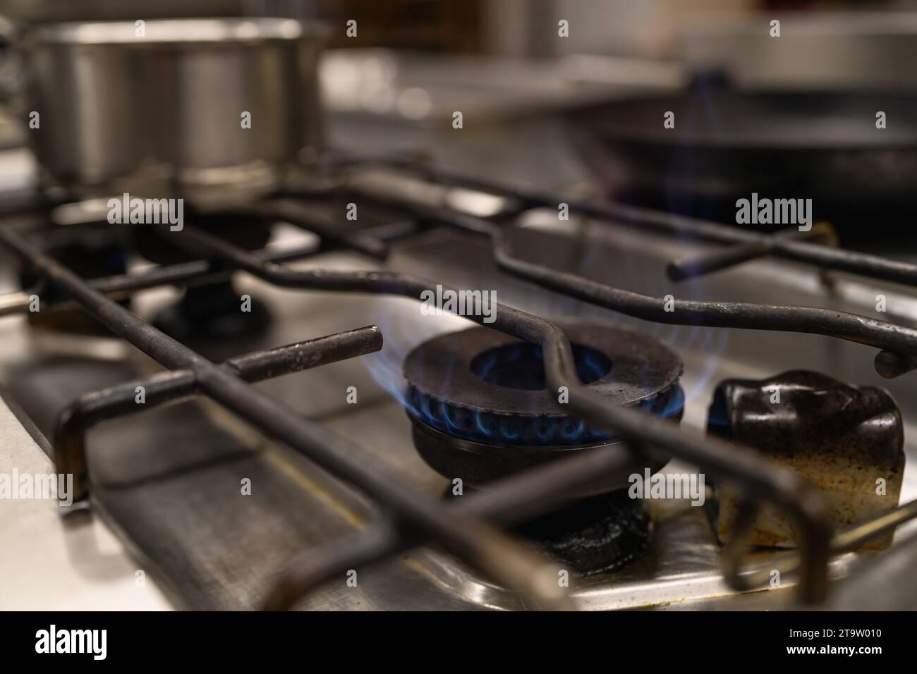 blue fire flames from a professional kitchen stove top. Gas cooker with burning flames of