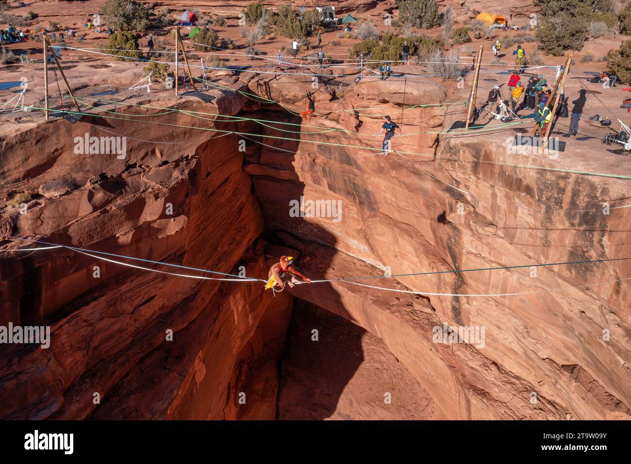 Aerial view of a person in a turkey costume highlining 500 feet above the canyon floor at the GGBY Highline Festival near Moab, Utah. Stock Photo