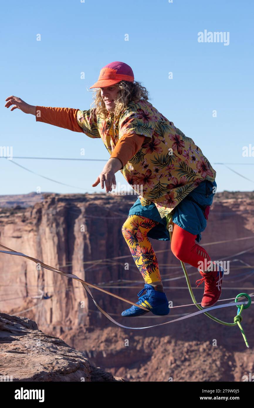 A young man walking a highline at the GGBY World Highline Festival in Mineral Canyon near Moab, Utah. Stock Photo