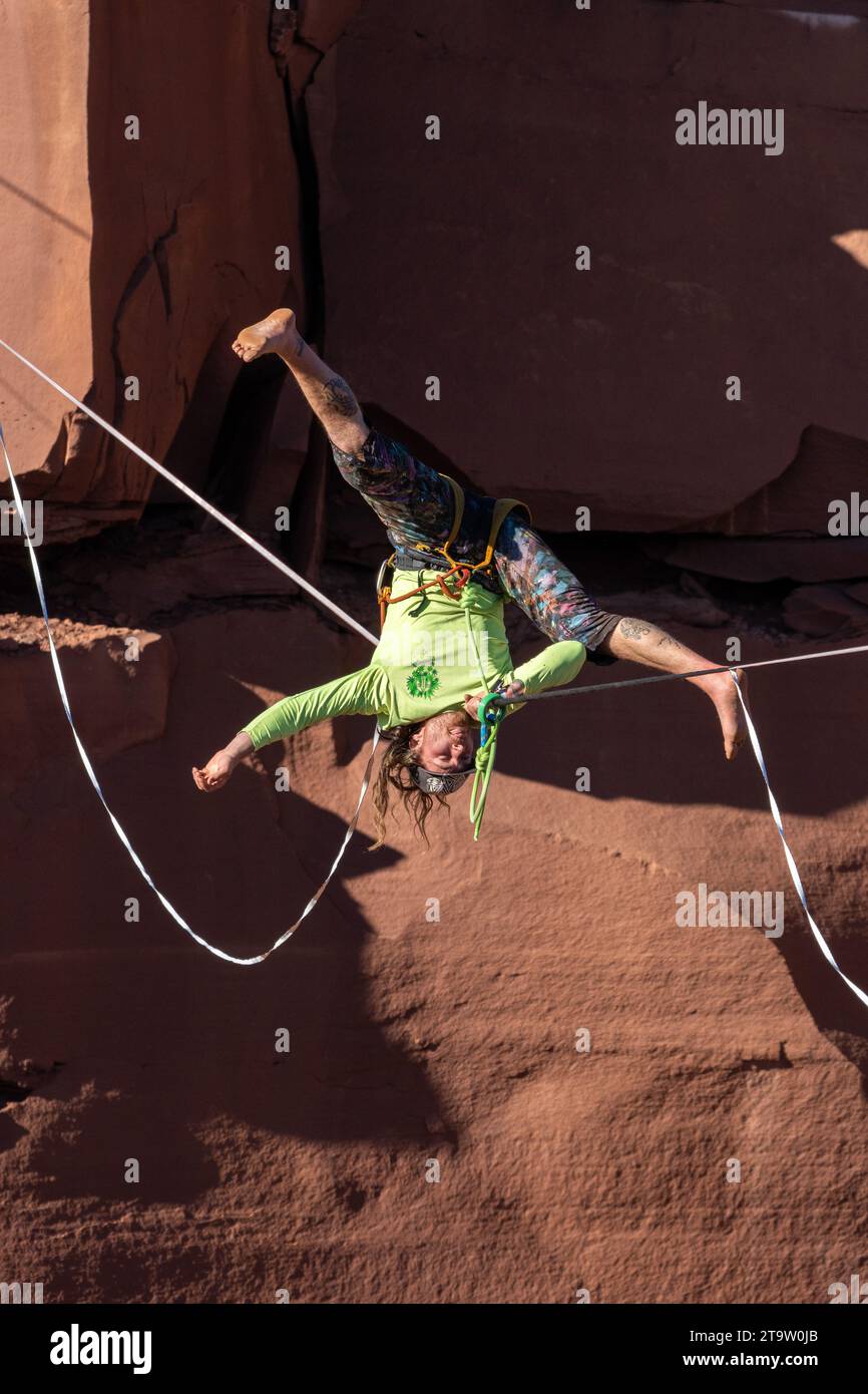 A freestyler does a shoulder stand on a highline at the GGBY World Highline Festival in Mineral Canyon near Moab, Utah. Stock Photo