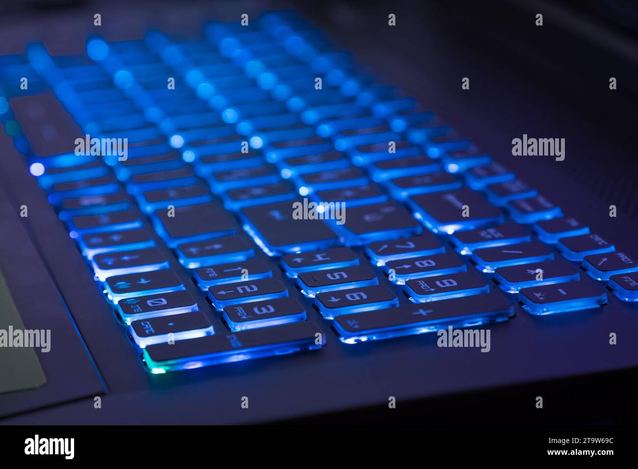 close-up of notebook keyboard with blue light tint, new technology Stock Photo