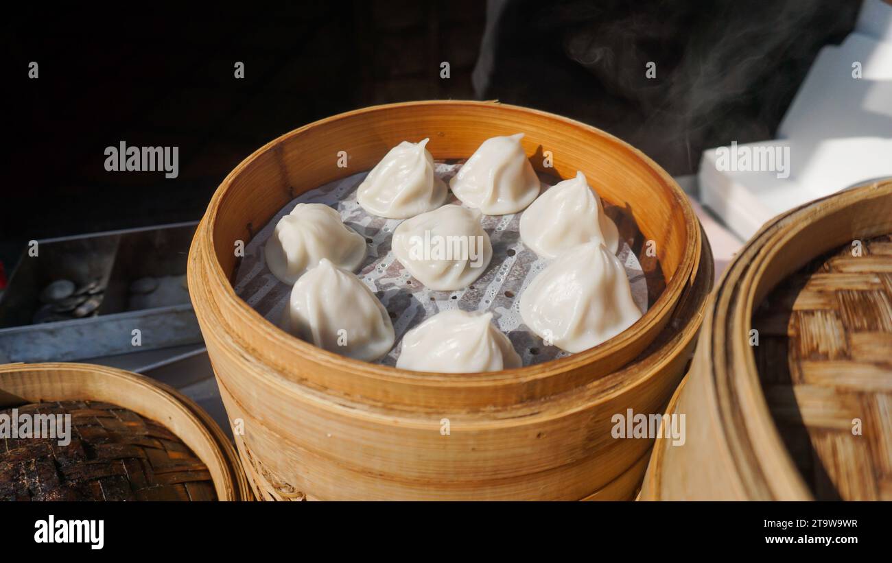Xiaolongbao steamed bun in bamboo basket. Steamed pork soup dumplings named Xiao long bao in Taiwan, Taiwanese famous gourmet. Stock Photo