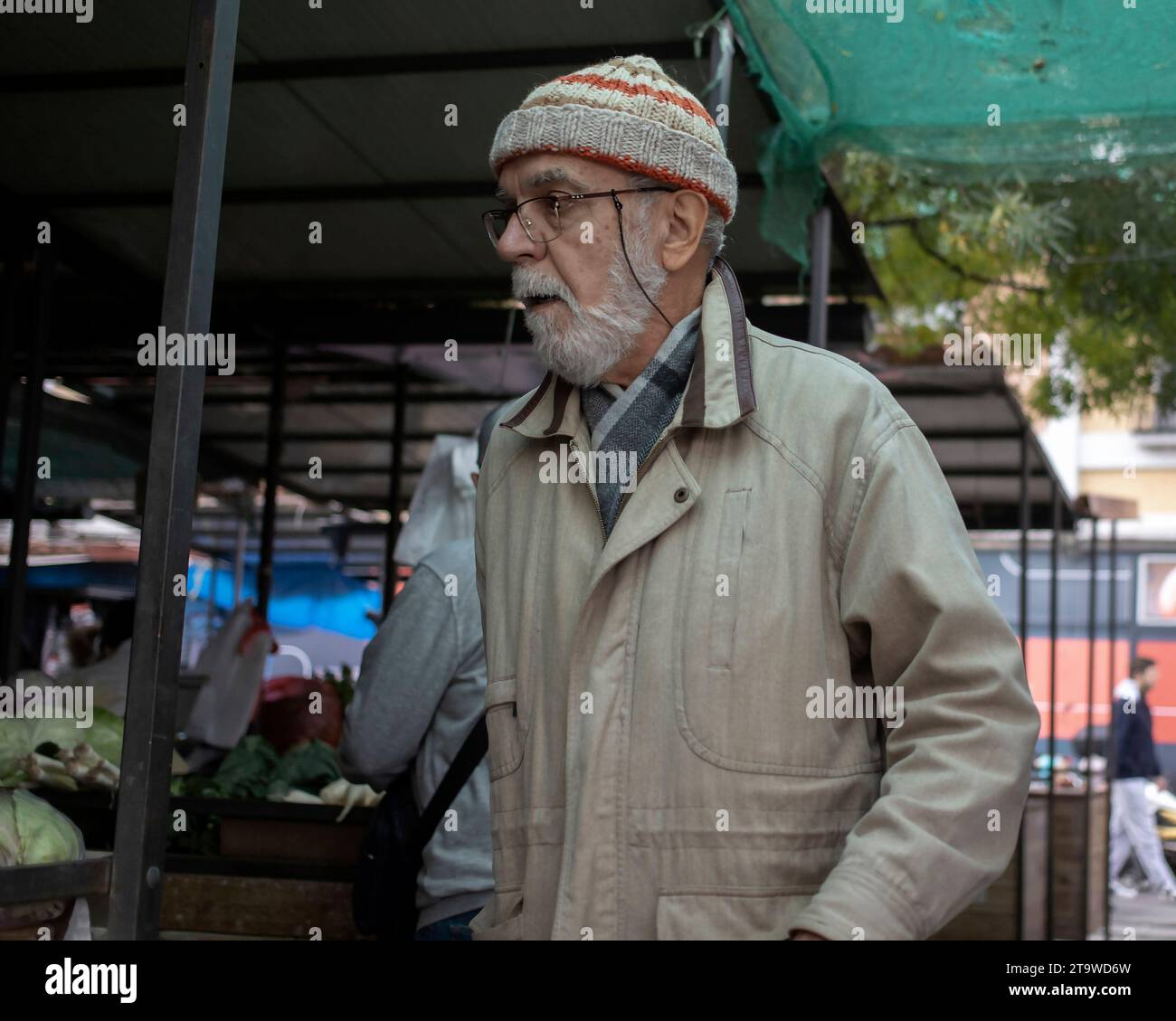 Belgrade, Serbia, Nov 10, 2023: Portrait of a senior citizen shopping at the green market Stock Photo