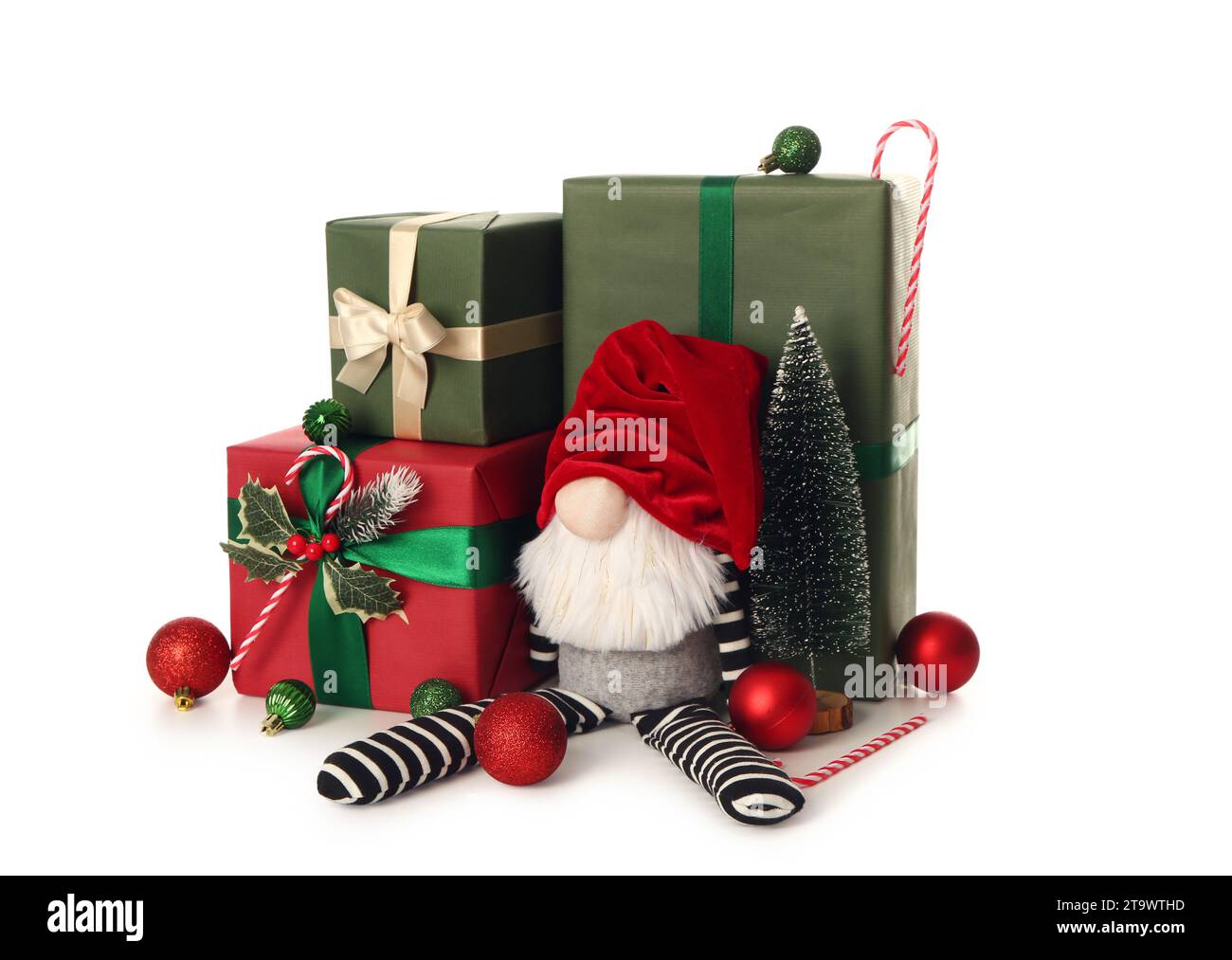 Christmas gnome with gift boxes, decorative fir, candy canes and balls ...