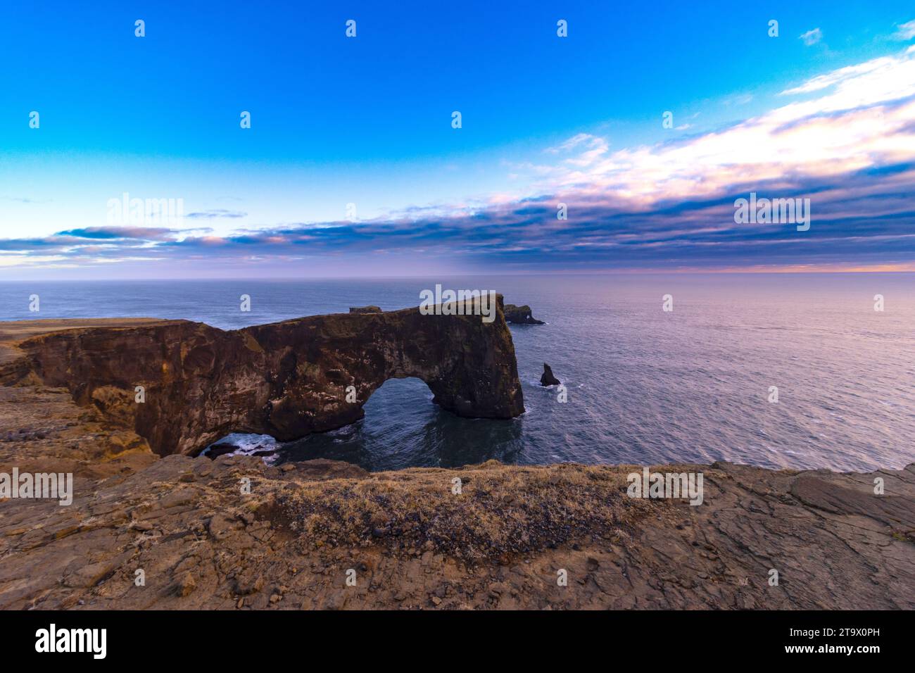 Cliff Dyrhólaey and its characteristic stone arches. Stock Photo