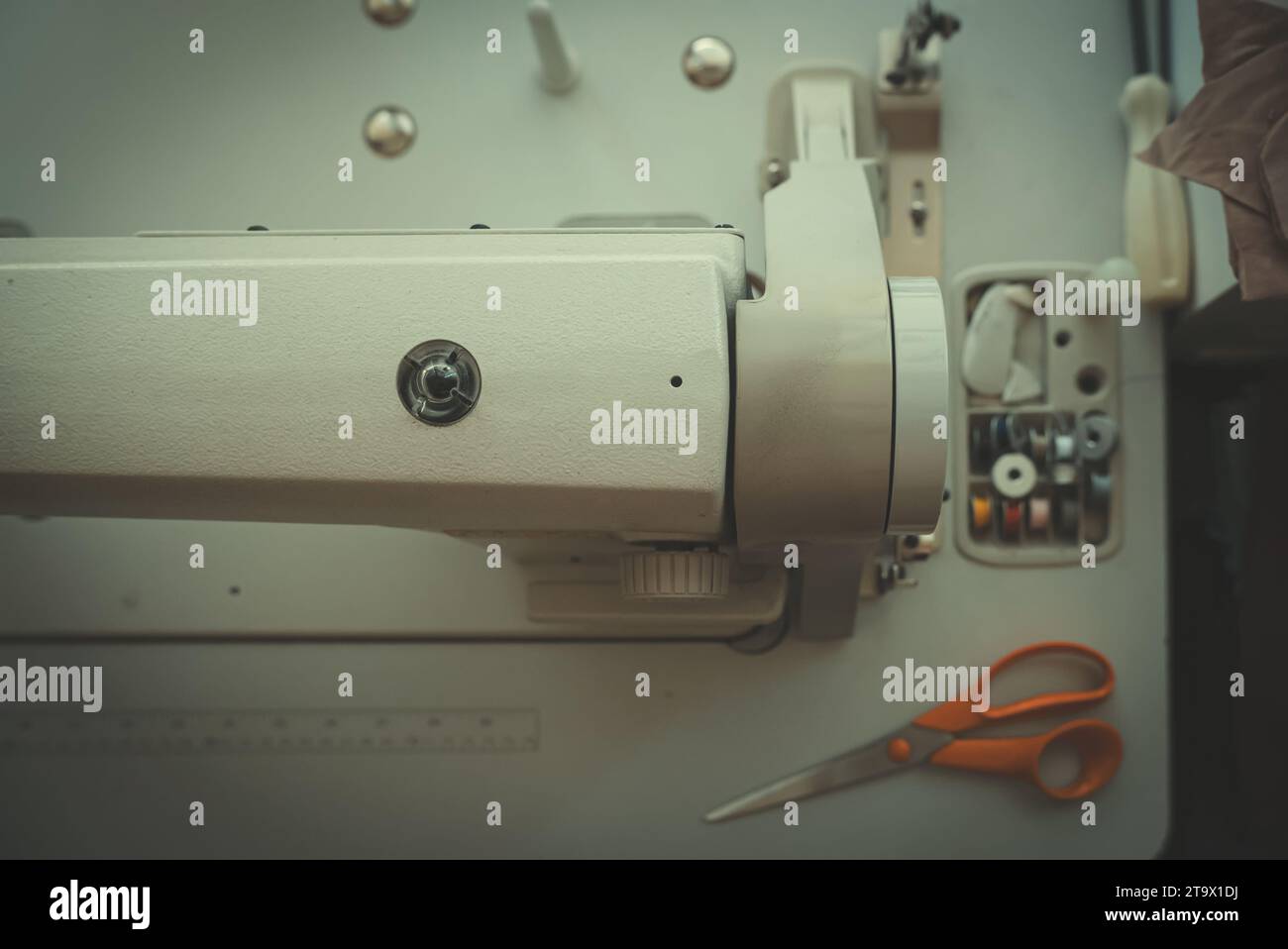 Sewing machine and threads on the table. Stock Photo