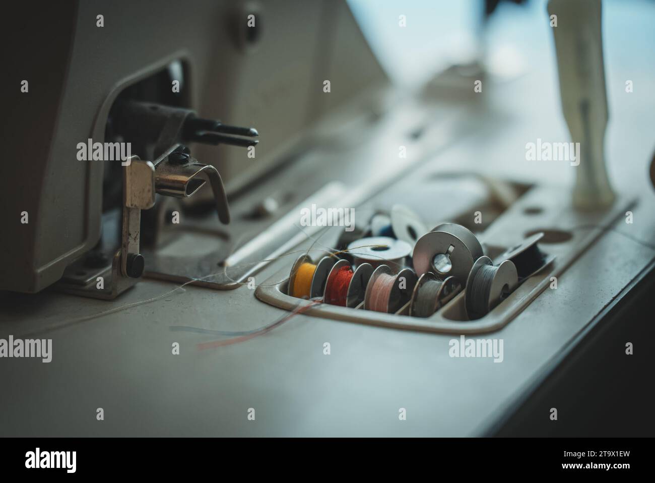 Sewing machine and threads on the table. Stock Photo