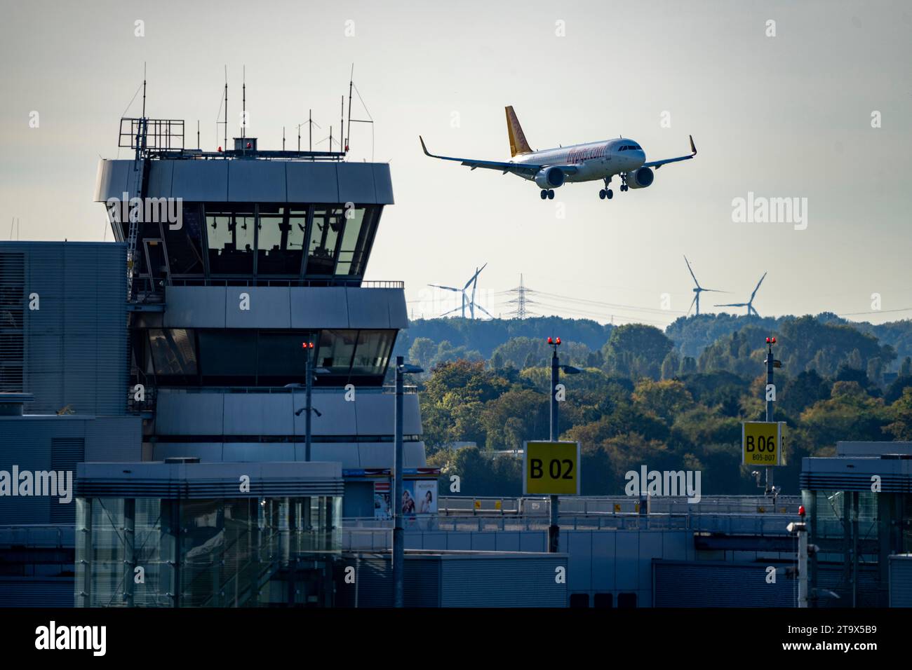 Düsseldorf Airport, Pegasus Airline, Airbus A321neo on approach, old air traffic control tower, Stock Photo