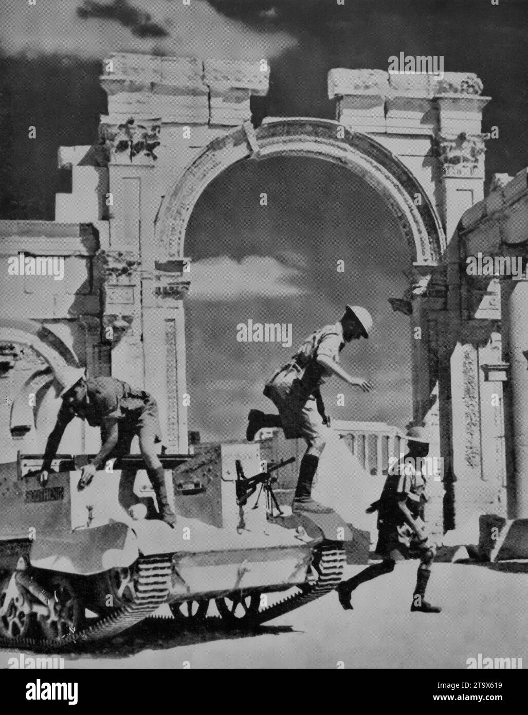 A bren gun carrier during the Second World War with Free French and Imperial troops stops outside the ruins of an old Roman colonnade in the city of Palmyra in Syria to deal with pockets of resistence. The city captured on  3rd July 1941, was important due to its proximity to an oil pipeline to Tripoli. Stock Photo