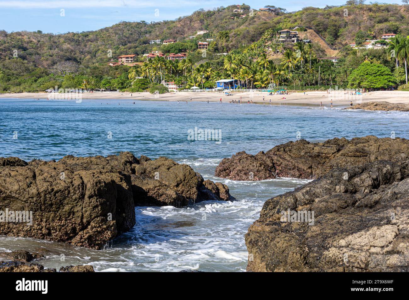 Playa Penca, Costa Rica - January 15, 2023: A general view of Playa Penca with rocks in the foreground.  Playa Penca is a little known but beautiful b Stock Photo