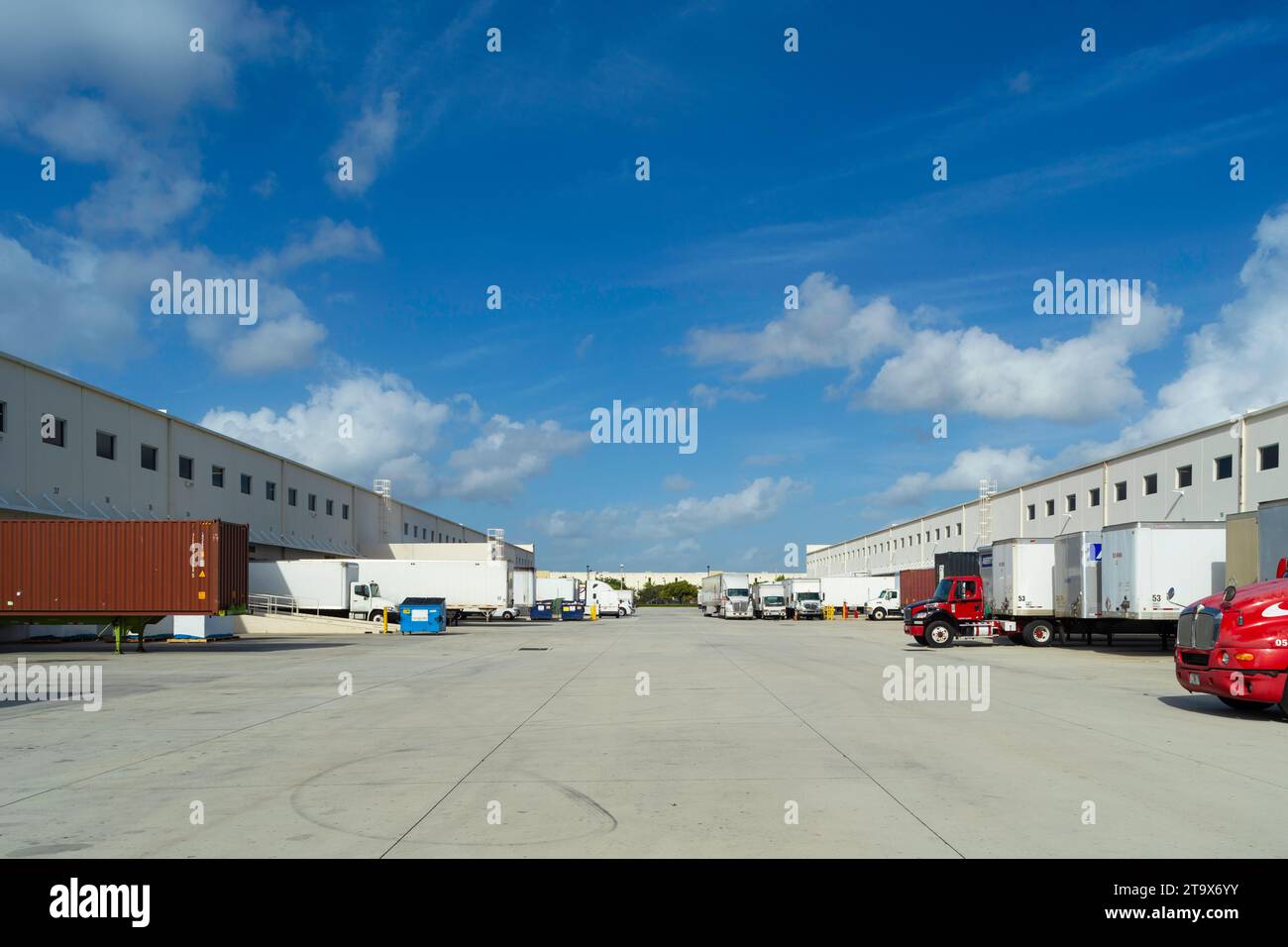 Distribution warehouse with delivery trucks parked on loading docks, Miami, Florida, USA Stock