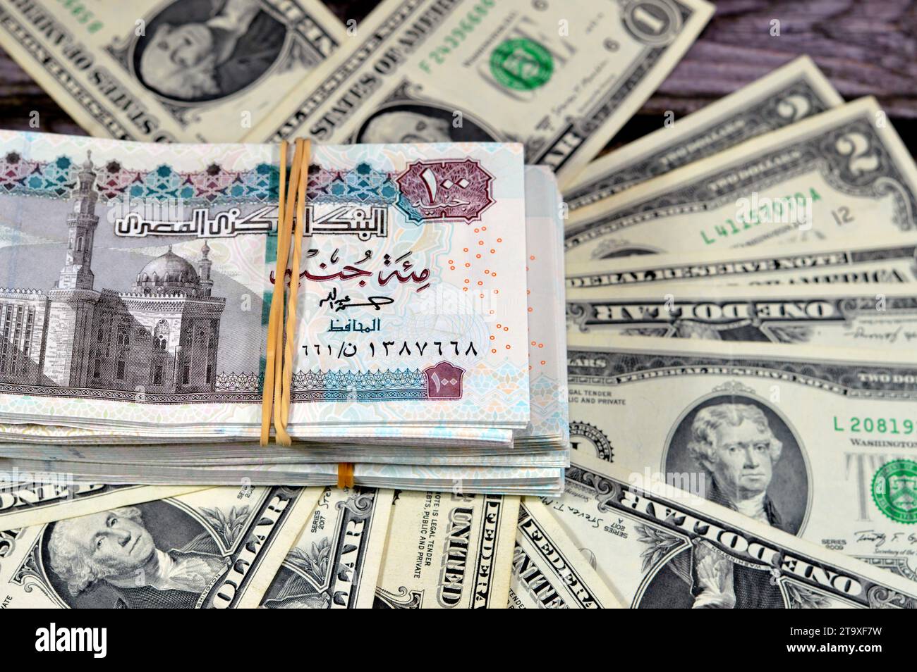 stack-of-egypt-money-banknote-bills-of-100-egp-le-one-hundred-egyptian-pounds-on-usa-american-dollars-currency-old-vintage-notes-egyptian-and-united-2T9XF7W.jpg