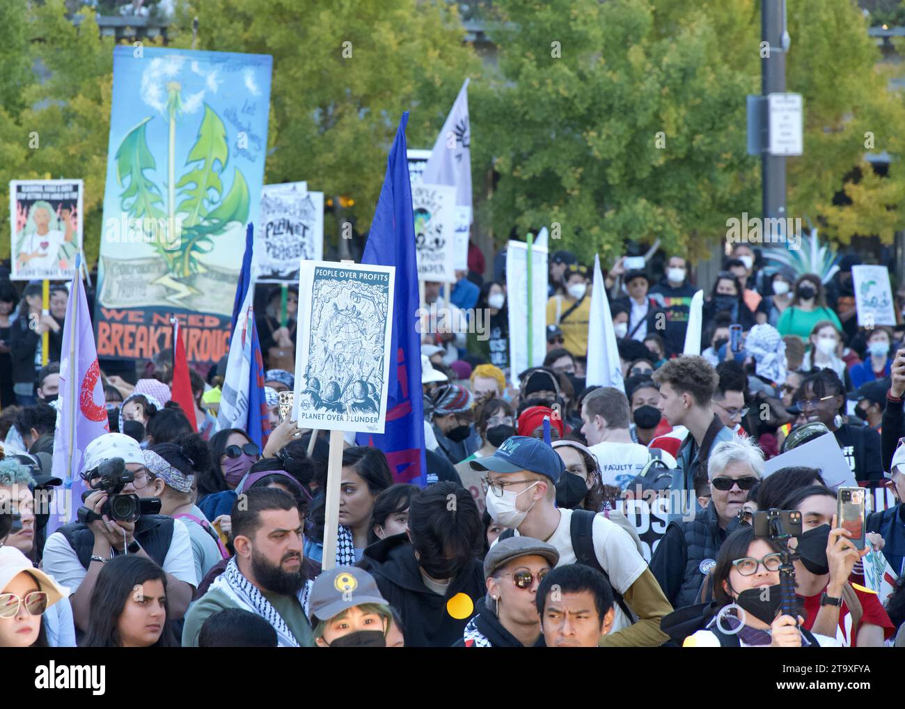 San Francisco, CA - Nov 12, 2023: Participants protesting APEC meeting in the city, joined by pro-Palestine protesters protesting the war. Marching up Stock Photo