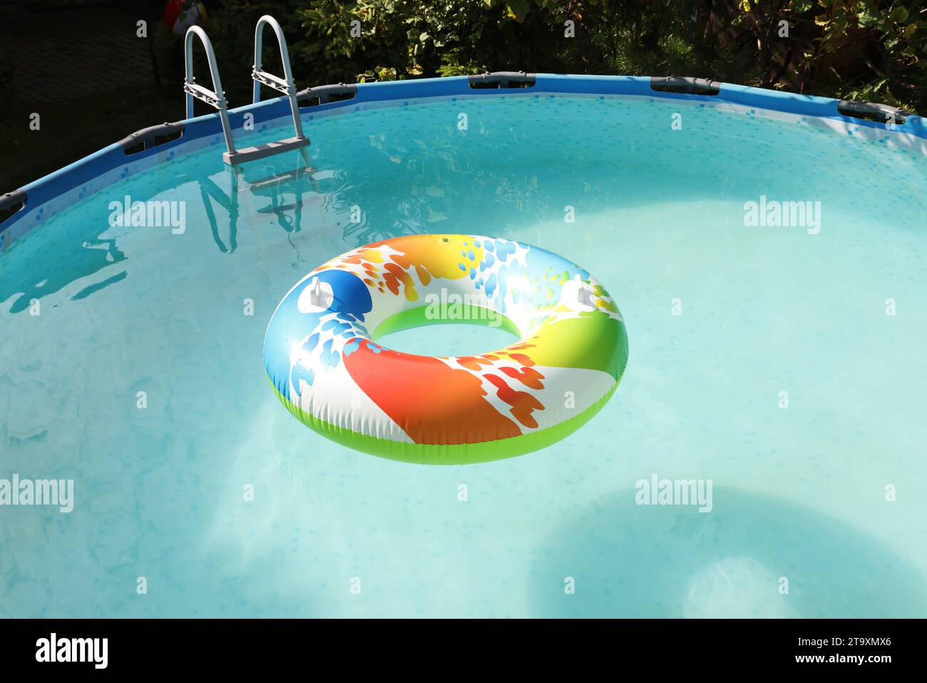 Inflatable ring floating on water in above ground swimming pool ...