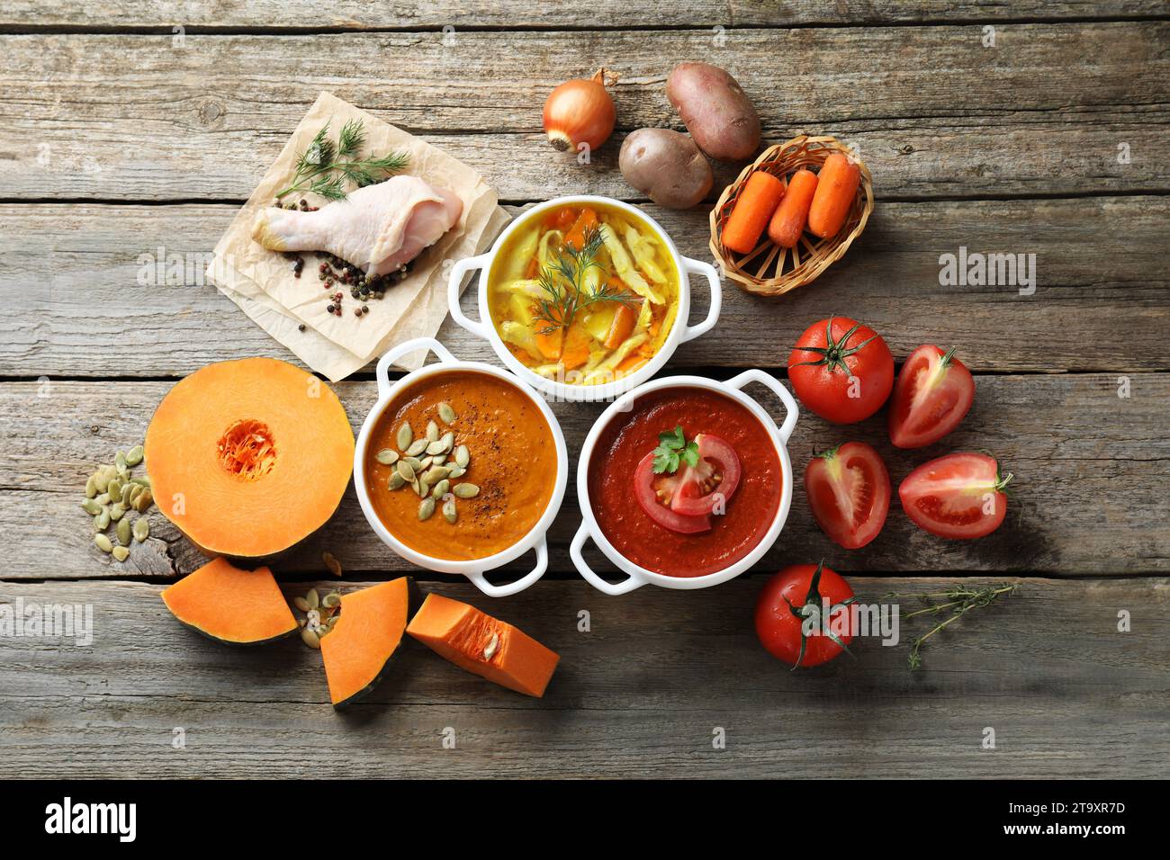 https://c8.alamy.com/comp/2T9XR7D/tasty-broth-cream-soups-in-bowls-and-ingredients-on-old-wooden-table-2T9XR7D.jpg