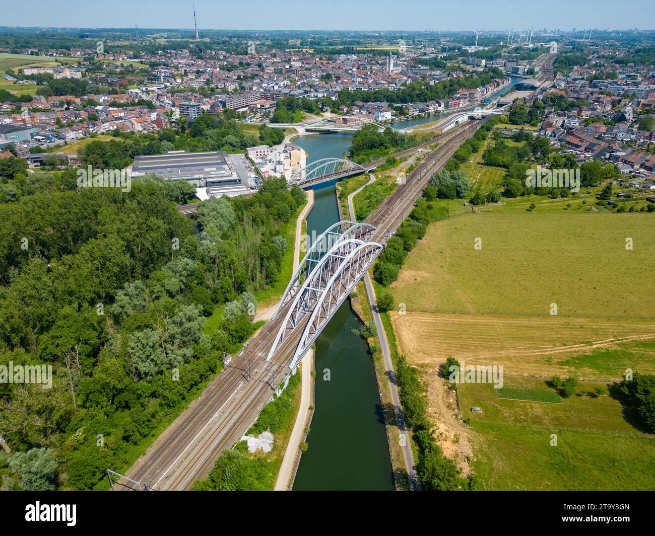This aerial photograph captures a modern bridge spanning a canal, a vital artery of 