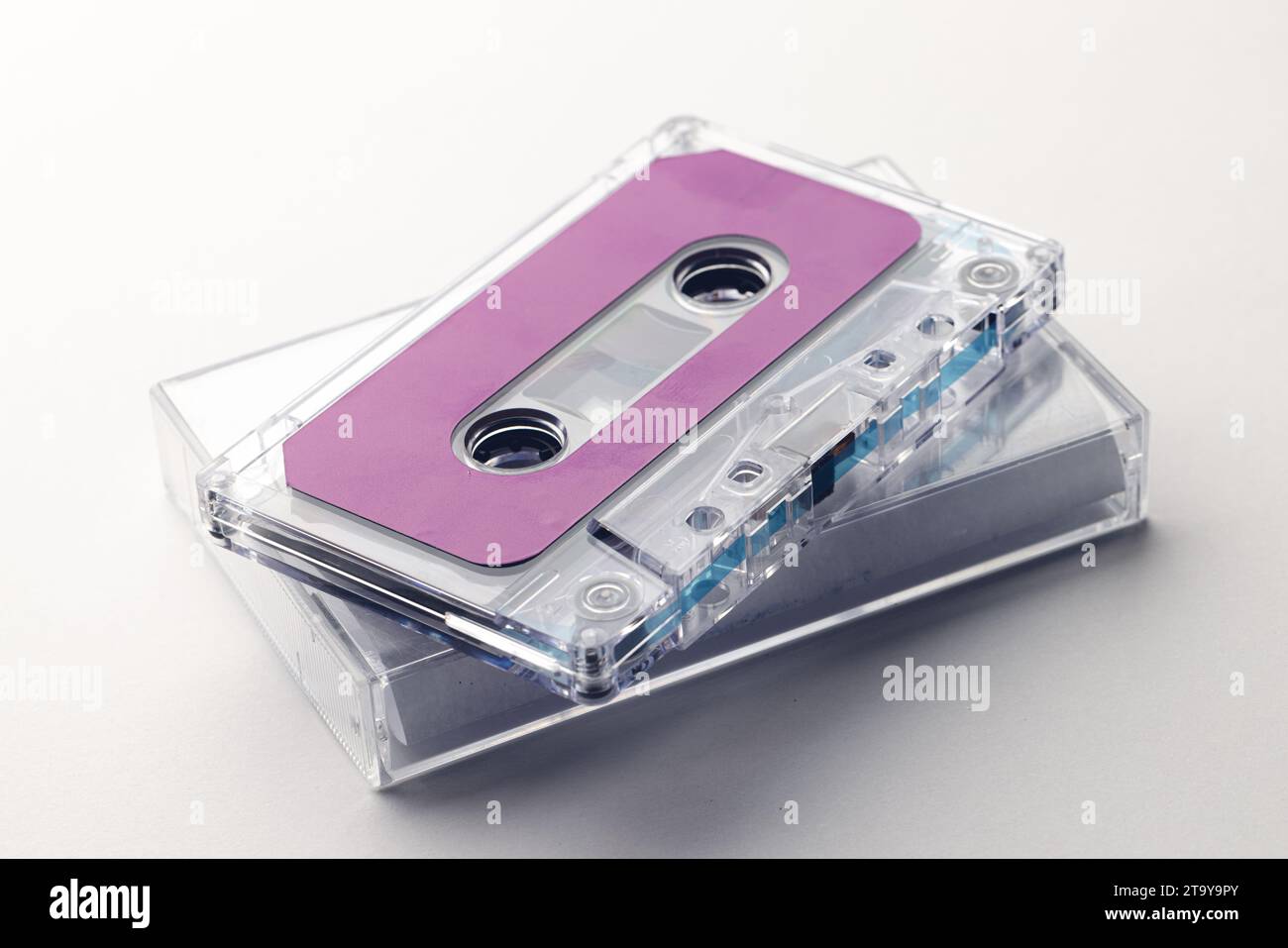 Close up of purple cassette tape and white box on white background Stock Photo
